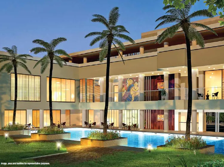Tata Avenida clubhouse exterior with palm trees and pool New Town Kolkata